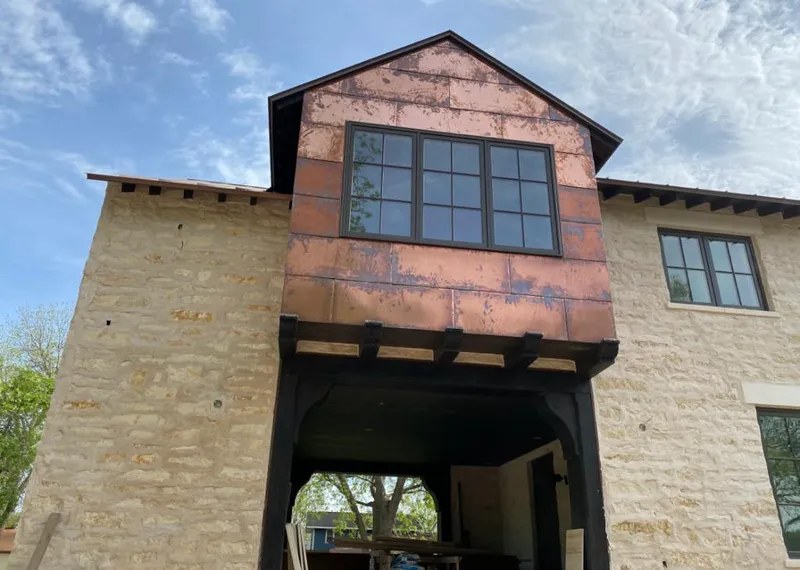 Copper metal panel facade on a stone building for Metal Roof Coating in Royal Oak